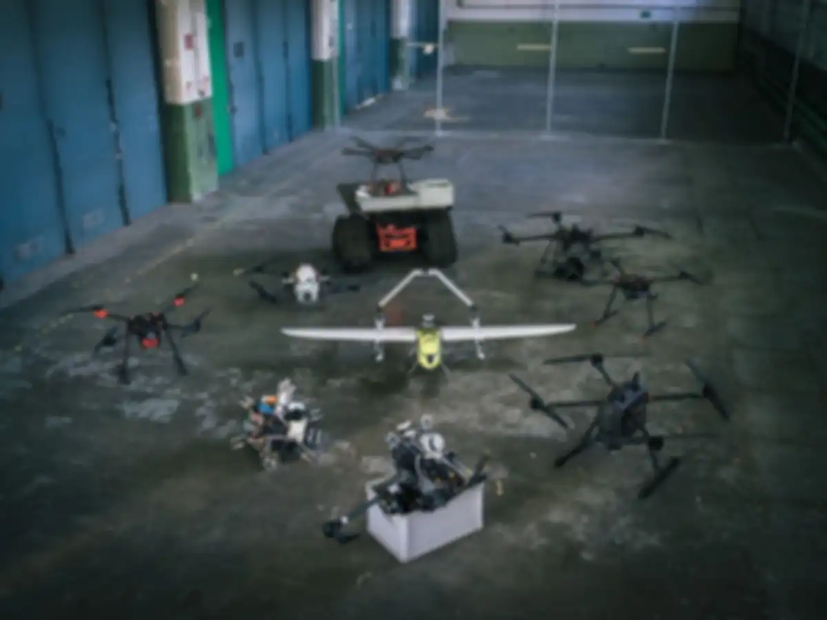 The participants' drones are set up in a hall.
